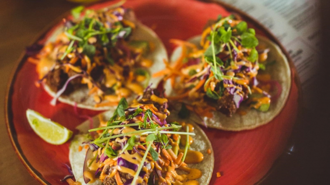 red plate with three tacos
