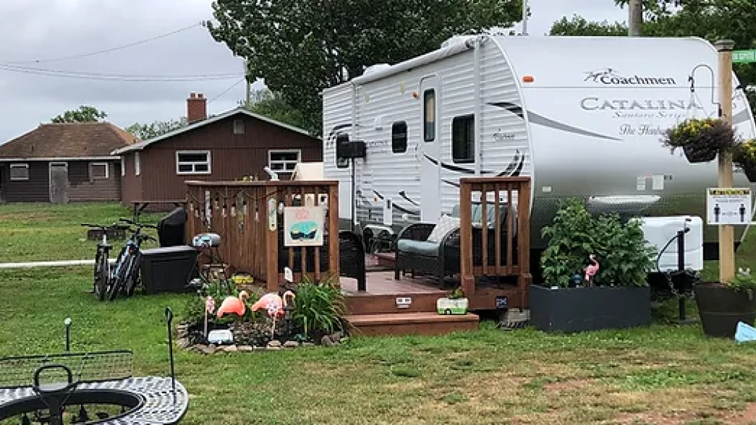 an RV with a nice fence and decorations