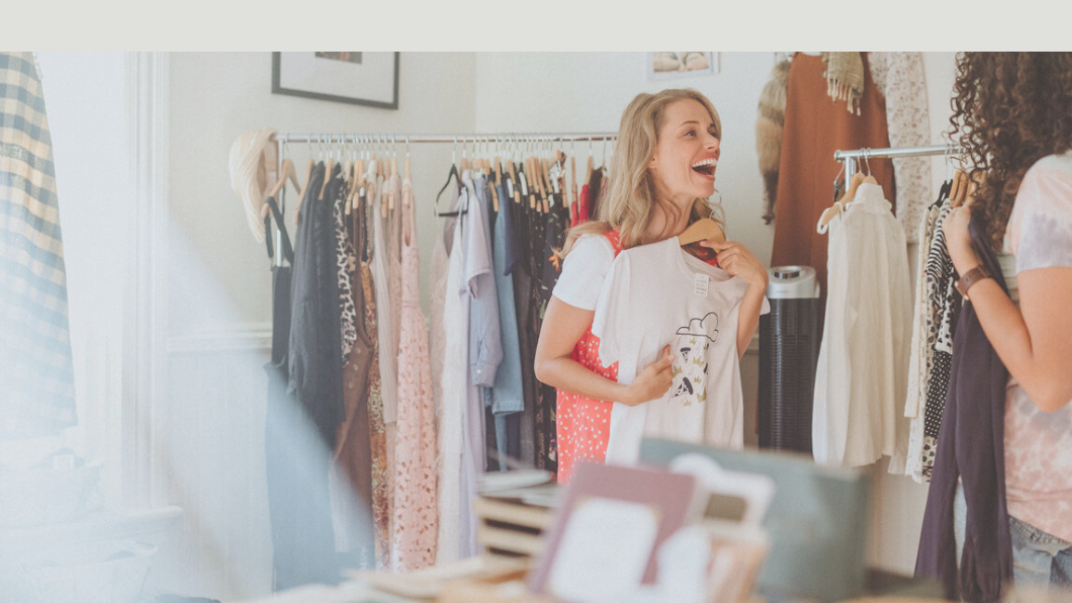 Two women shopping and laughing in a store