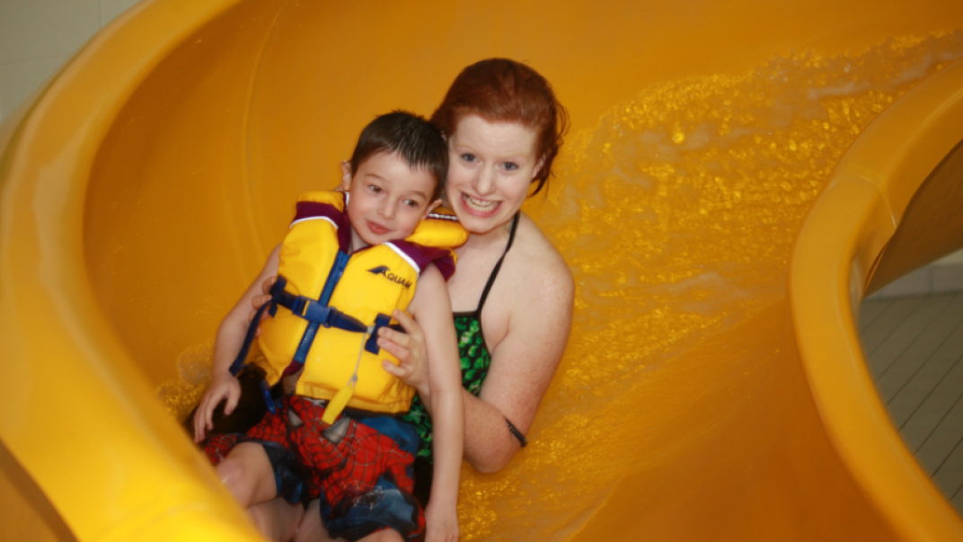 Woman and child going down waterslide