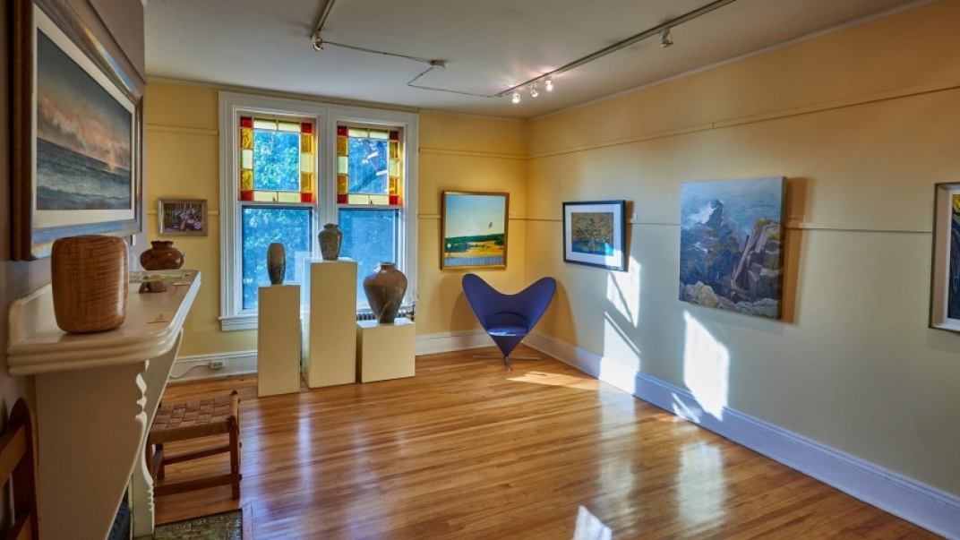 Gallery interior with paintings, pictures, and sculptures on display