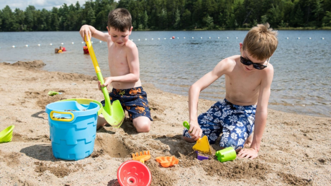 Two boys playing in the sand