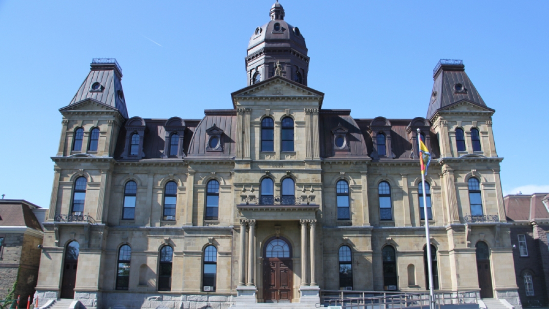 Exterior of legislative assembly building. The building is fashioned in Victorian architecture.
