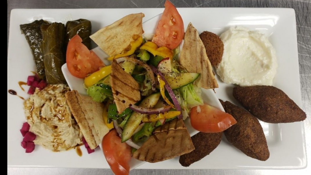 an appetizer plate with a dipping sauce