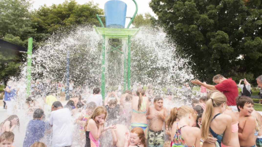 Children at waterpark getting splashed with water