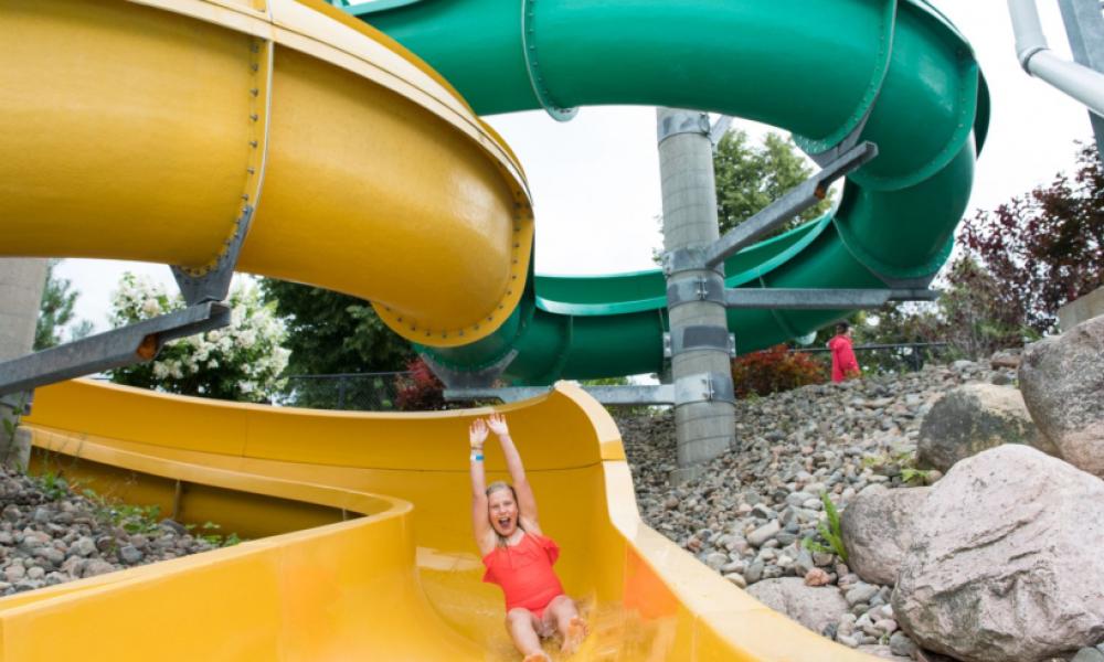 Girl going down yellow water slide